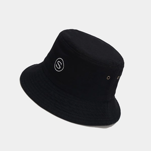 Detailed view of black cotton bucket hat featuring white S embroidery and metal eyelets