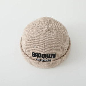 Detailed macro view of the Brooklyn embroidery and ribbed texture on the corduroy docker cap