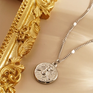 Silver bee pendant necklace with minimalist round disc for women on a vintage gold frame