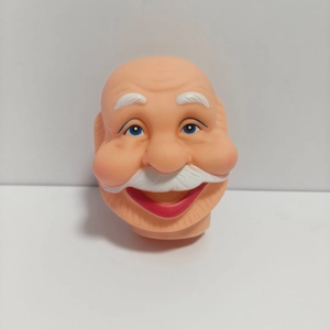 Macro view of a smiling 3D vinyl Santa Claus head with blue eyes and white beard