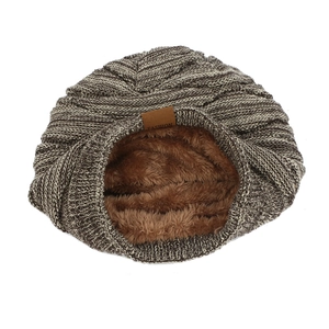 Detail of warm winter knit beanie showing fleece lining and fashion leather patch