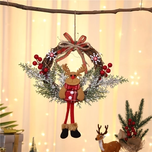Detail of Christmas wreath with plush reindeer, red berries and festive plaid bow