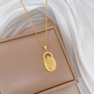 Macro shot of gold-plated Virgin Mary portrait pendant with sparkling cubic zirconia crystals