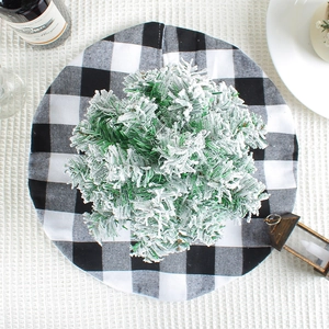 Christmas tree skirt with buffalo plaid pattern and flocked green tree for festive decor