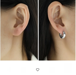 Detailed comparison of gold and silver thick hoop earrings worn on a model's ear