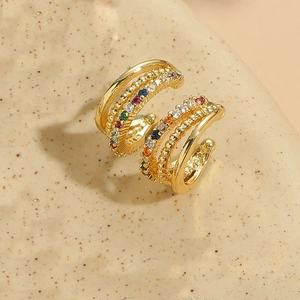 Macro detail of 18K gold-plated triple-layer ear cuff with rainbow zircon stones