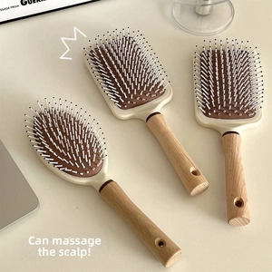 Close-up of beech wood massage hairbrushes with anti-static air cushions in various shapes