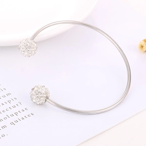 Detail of silver-tone C-shaped cuff bracelet with two sparkling rhinestone spheres