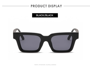 Close-up of black square thick frame sunglasses showing polished texture and dark lenses