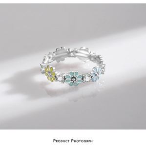 Macro shot of S925 sterling silver ring with colorful enamel flowers and tiny zircons