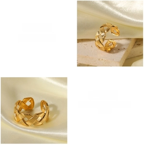 Macro detail of golden braided twist ring texture and adjustable open band design