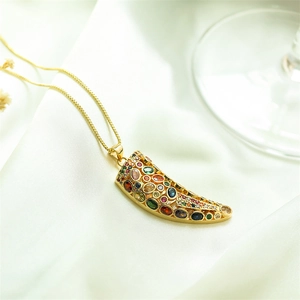 Luxury gold horn pendant necklace with colorful zircon gemstones on white silk fabric