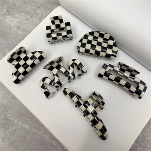 Classic black and white checkered hair claw clips set in various geometric shapes