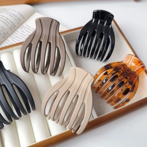 Set of large matte and tortoiseshell hair claws in a minimalist wooden display box