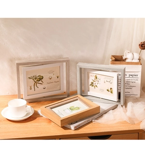 Detailed view of rotating double-sided wooden frames in 5x7 inch size with wood grain texture