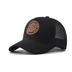 Black cotton trucker hat with brown leather patch and breathable mesh back panel