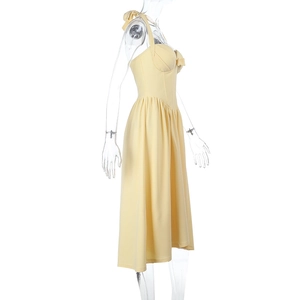 Detailed side view of yellow halter neck dress with bow waist and pleated A-line skirt