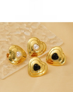 Detail of 18K gold plated heart earrings with pearl and black enamel inlays