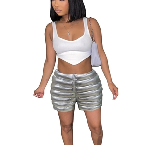 Detail of silver metallic quilted thermal shorts and white ribbed tank top on model