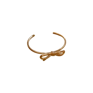 Bracciale rigido aperto minimalista placcato in oro con design centrale a fiocco