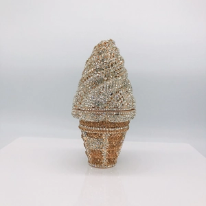 Macro shot of sparkling champagne gold and silver rhinestones on ice cream clutch bag