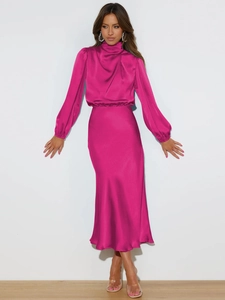Detail of fuchsia satin halter dress showing elegant silk texture and fabric drape