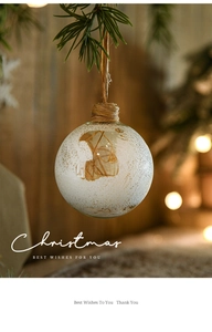 Close-up of 8cm glass Christmas ball with snowflake patterns and dried plant filling