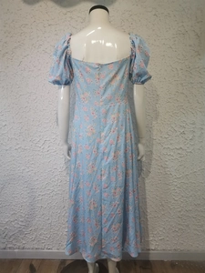 Detail of floral puff sleeve dress back with zipper closure and light blue pattern