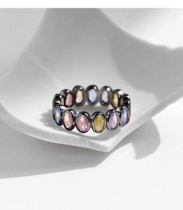 Close-up of black S925 silver ring set with colorful oval-cut cubic zirconia gems