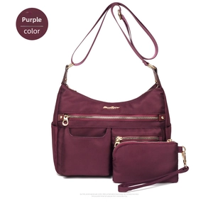 Close-up of waterproof purple nylon shoulder bag with zip pockets and matching pouch