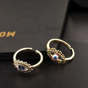 Macro view of adjustable gold enamel eye rings with sparkling colorful zircon stones