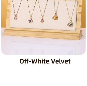 Detail of wooden necklace display stand with off-white velvet and various pendants