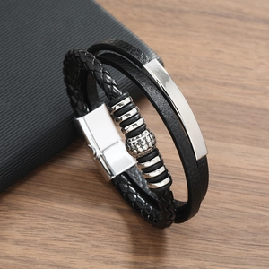 Close-up of multilayered black braided leather bracelet with silver metal magnetic clasp