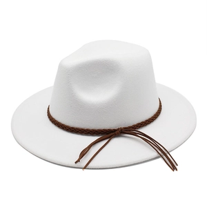 Detail of white wool fedora hat featuring a brown braided leather band and tassel detail