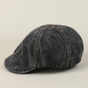 Close-up of vintage washed black denim ivy cap with orange contrast stitching detail