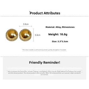 Macro view of gold round stud earrings with rhinestone borders and alloy texture details