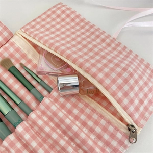 Detail of pink plaid makeup brush bag with Fix+ slots and secure zipper storage