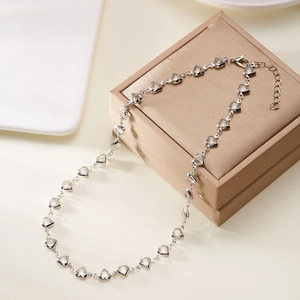 Detail of silver chain necklace with transparent heart crystals and adjustable clasp
