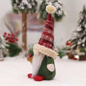 Nordic Christmas gnome plush with red plaid hat and pine cone in a snowy forest background