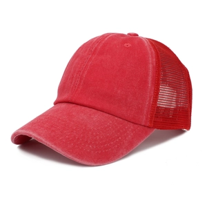 Close-up of red washed cotton baseball cap featuring breathable mesh and distressed finish