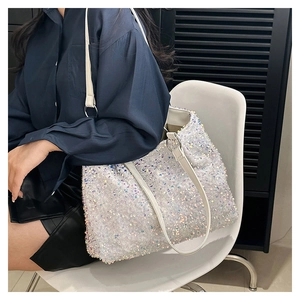 Detail of a white iridescent sequin tote bag with smooth white PU leather handle