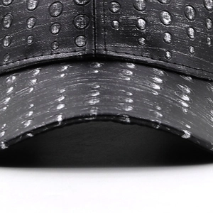 Macro detail of PU leather baseball cap with reflective silver water drop patterns