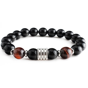 Detail of 10mm tiger eye and black obsidian beaded bracelet with silver metal cylinder
