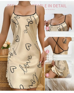 Detail view of champagne gold satin nightdress featuring black love print and thin straps
