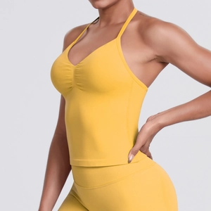 Detail of yellow high-support halter sports bra with ruched front and elastic fabric