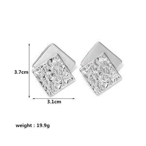 Detailed view of silver square earrings with hammered texture and size measurements