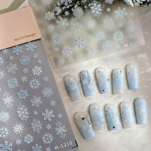 Winter snowflake nail art stickers with 3D embossed designs and blue gradient faux nails