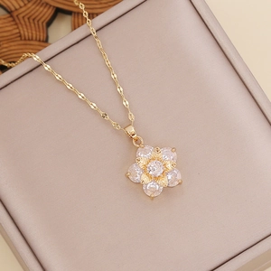 Elegant gold-plated multi-layer flower necklace with zircon petals on a beige jewelry box