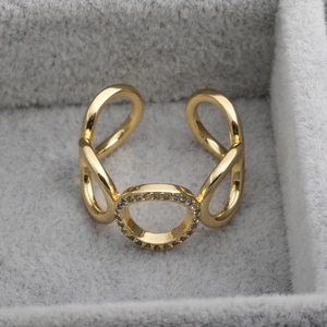 Macro shot of gold-plated open ring featuring a sparkling micro-pave infinity circle