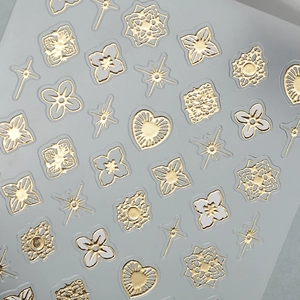 Vintage gold foil nail art stickers with hollow floral patterns and star motifs